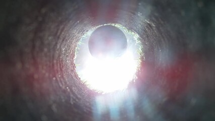 Super slow motion of golf ball falls into the hole at the camera, view inside the hole close-up. Filmed on high speed cinematic camera at 1000 fps.