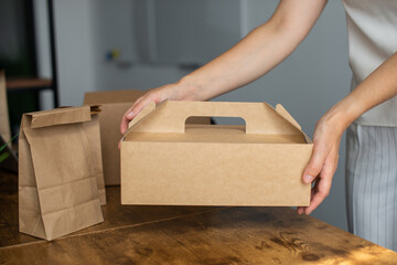 A mock-up of a disposable food box in the hands of a woman
