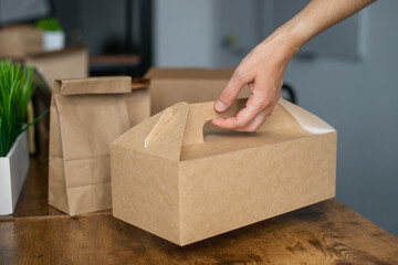 Craft food box with a handle in a person's hand