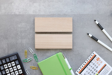 wooden blocks on a gray background. green notepad calculator. Top view with copy space. Business design concept