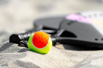 Racket and ball on the sandy beach. Summer sport concept. Horizontal sport theme poster, greeting cards, headers, website and app