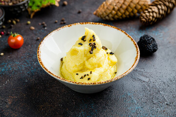 mashed potatoes with truffle on bowl on dark table
