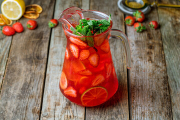 Strawberry lemonade with lime on wooden table side view