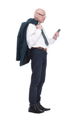 man with a jacket over his shoulder reading a message on his smartphone