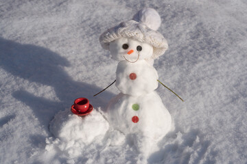 Snowman with cup coffee. Snow man isolated on snow background.