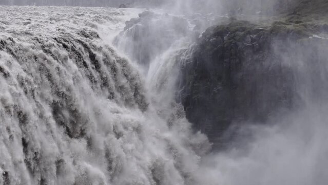 Close up of water falling from Dettifoss waterfall in abstract. Movement of water falling. Power of water