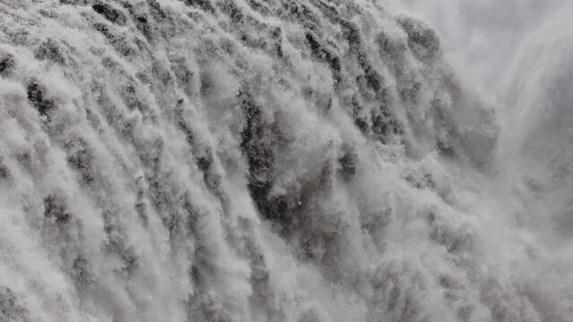Close up of water falling from Dettifoss waterfall in abstract. Movement of water falling. Power of water