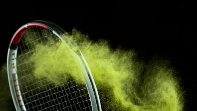 Super Slow Motion Shot of Racket Hitting Tenis Ball Containing White Powder at 1000 fps.