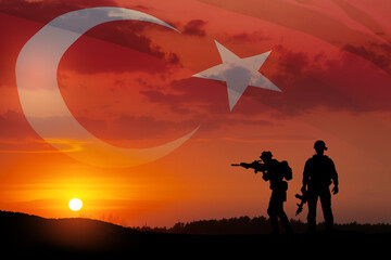 Silhouettes of soldiers on a background of Turkey flag and the sunset or the sunrise. Concept of crisis of war and conflicts between nations. Greeting card for Turkish Armed Forces Day, Victory Day.