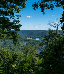 Fototapeta na wymiar The view from the Tidoute Overlook at the Allegheny River flowing through the river valley in Warren County, Pennsylvania, USA on a sunny summer day