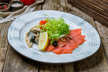different fish slicing on a plate on wooden table