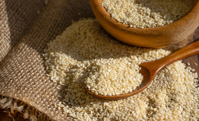 Sesame seeds spoon on old background