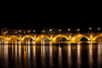Fototapeta na wymiar Night view of the famous bridge of Bordeaux called Le Pont de Pierre