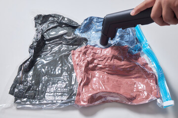 Space saver saving seal bag sucking air vacuum clothing storage compressed package.