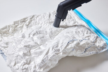 Space saver saving seal bag sucking air vacuum clothing storage compressed package.
