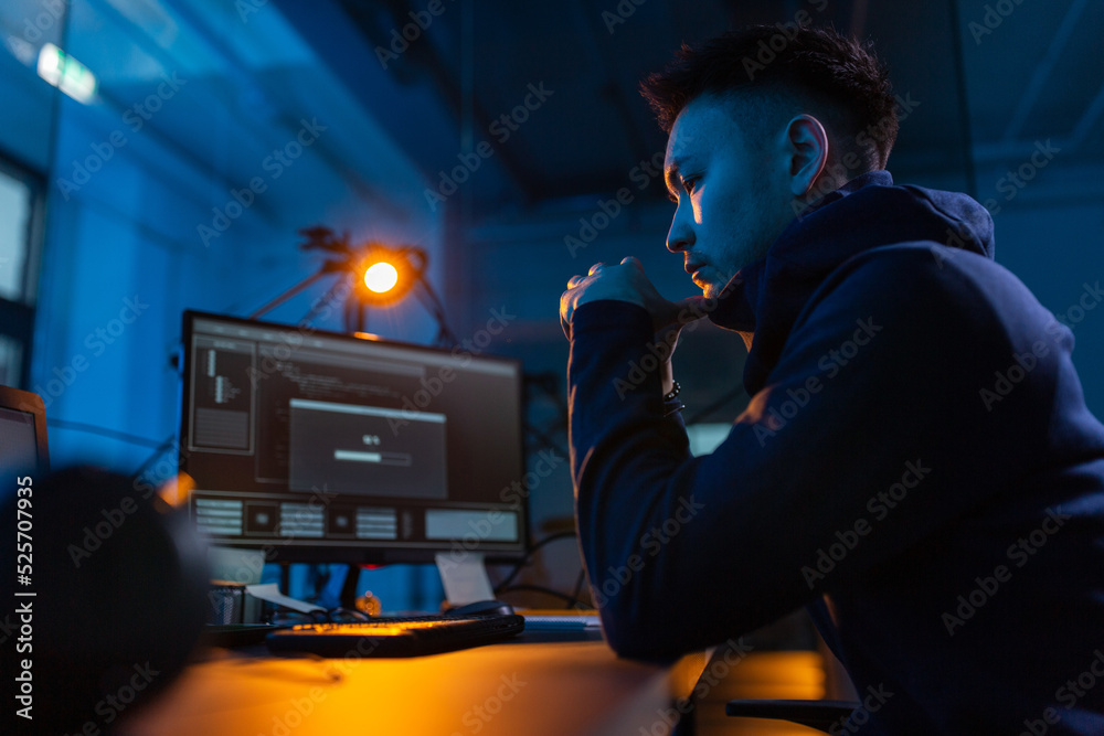 Poster cybercrime, hacking and technology concept - male hacker in dark room using computer virus program f