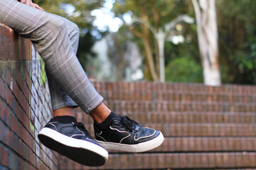 man's legs with black shoes