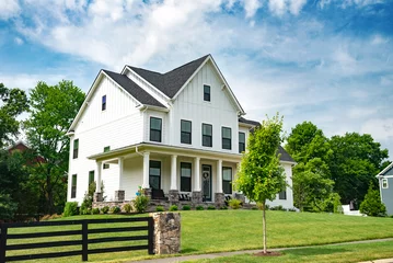 Papier peint photo intissé Landscape with  large country house. Large mowed lawn and blue sky.