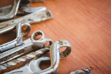 Fototapeta na wymiar close up of rusty hand tools above an wood table