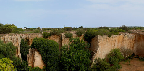 Fototapeta premium Lithica, Pedreres de s'Hostal, Menorca (Minorca) island, Spain. The sandstone quarries overgrown by trees and vegetation with labirynths and gardens