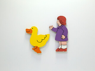 Illustration of girls with their duck. Drawn figures. Nice couple of girl and her pet. Educational figures for toddlers and babies. Game for children. Baby pets. Drawings on white background.