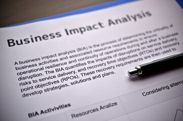 There is dummy documents that created for the photo shoot on the desk about Business Impact Analysis.