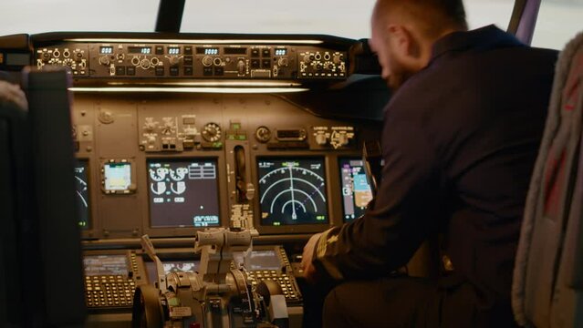 Aviation captain putting coordinates to fly airplane to destination, using dashboard command buttons in cockpit. Flying aircraft with ciontrol panel and power switch, using lever and compass.