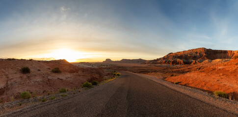 Scenic Road in Red Rock Mountains in the Desert at Colorful Sunrise. Spring Season. Goblin Valley State Park. Utah, United States. Nature Background Panorama