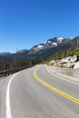 Scenic Road surrounded by Trees and Mountains on a Sunny Day. Summer Season. Lake Tahoe, California, United States. Adventure Travel.