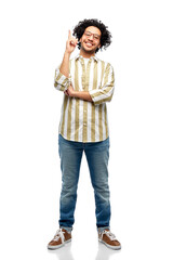 Fototapeta premium people and fashion concept - happy smiling man in glasses pointing finger up over white background
