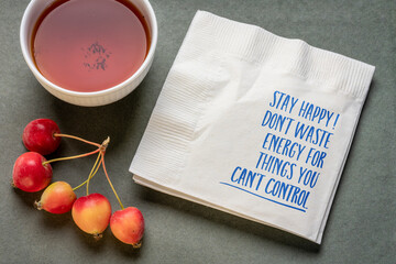 stay happy, don't waste energy for things you can't control - inspirational reminder note on a napkin, happiness and personal development concept