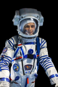 Russia, Sochi Magic park 24.04.2022.Wax figure of an astronaut. Figure of an astronaut in a spacesuit. Cosmonaut in a space suit with space symbols. Blurred image