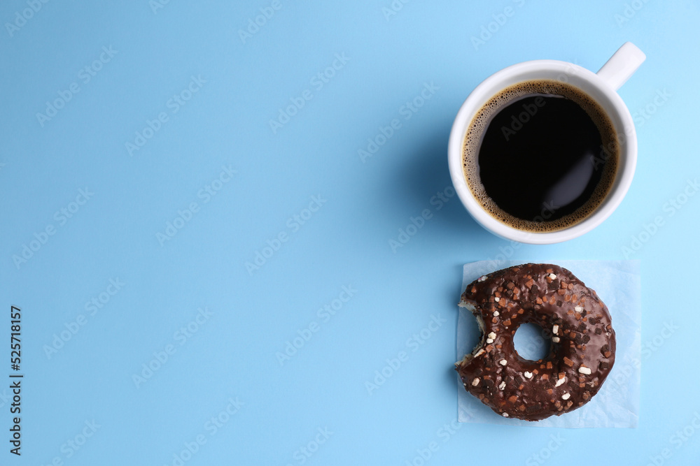 Sticker Tasty donut and cup of coffee on light blue background, flat lay. Space for text