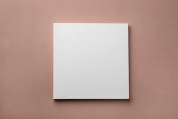 Blank canvas on pale pink wall. Space for design