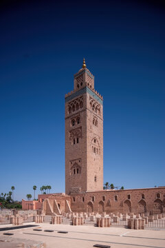 Koutoubia Mosque Minaret in Morocco Marrakesh and gardens during sunset with blue sky. Inside Medina.