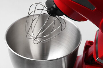 Modern red stand mixer on light grey background, closeup