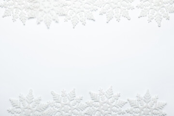 Fototapeta premium Beautiful decorative snowflakes on white background, flat lay. Space for text