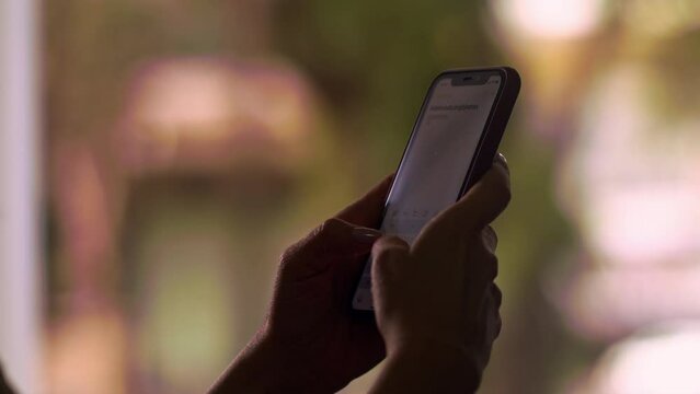 Anonymous woman's hands typing notes in iPhone notes application