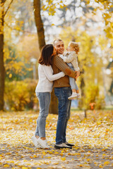 Fototapeta premium Cute and stylish family playing in a autumn field