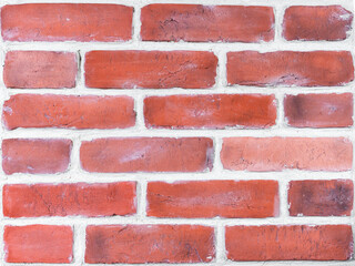 Obraz premium Wall is made of red decorative brick facade decoration. Plaster blocks based on casts of old bricks. Restoration of old buildings and facades. Hobby, craft