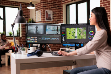Content creator working with video editing software to create professional montage with audio and...