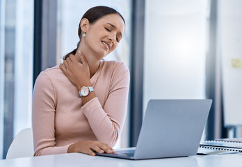 Stress woman suffering from neck pain working on a laptop in a modern office. Corporate...
