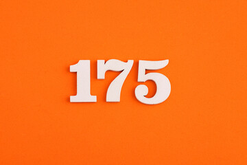White wooden number 175 on eva rubber orange background
