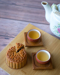 Moon cake served with chinese tea. Mid-autumn festival concept. Copy space.