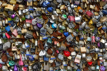 Fototapeta na wymiar Pile of padlocks on a fence