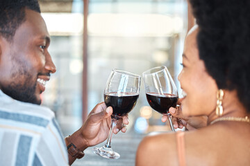 Couple giving cheers, toast and celebrate with wine glass, champagne and alcohol drinks on a romantic date together. Love, relax and smile black people in celebration of happy marriage relationship