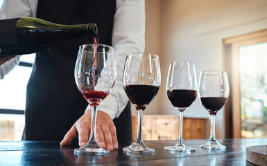 Red wine tasting with luxury, quality alcohol in glasses for fine dining food, culinary or hospitality industry. Sommelier service or serving vintage alcoholic drink at a classic classy restaurant