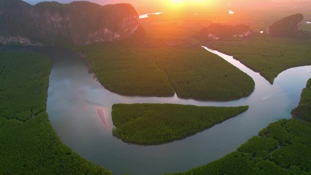 An aerial view from a drone flying over Phang Nga Bay in sunset time, beautiful river bend and many islands in the background. (Samed Nang Chee), Phang Nga, Thailand. beauty of nature concept. 4K
