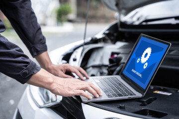 Car mechanical engineering using laptop computer examining tuning fixing repairing car engine...