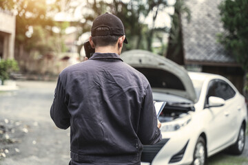Car mechanical engineering working at workshop garage.